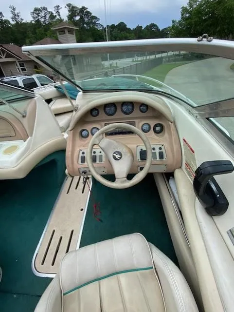 Slide: The Image of 1995 Sea Ray 200 Signature boat dashboard with steering wheel and gauges. - 5