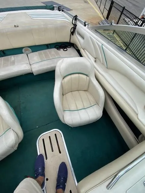 Slide: The Image of 1995 Sea Ray 200 Signature boat interior with white seating and green carpet. - 6