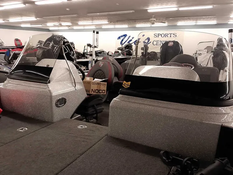 Slide: The Image of 2021 Triton 206 Allure boat displayed indoors at a sports center showroom. - 11