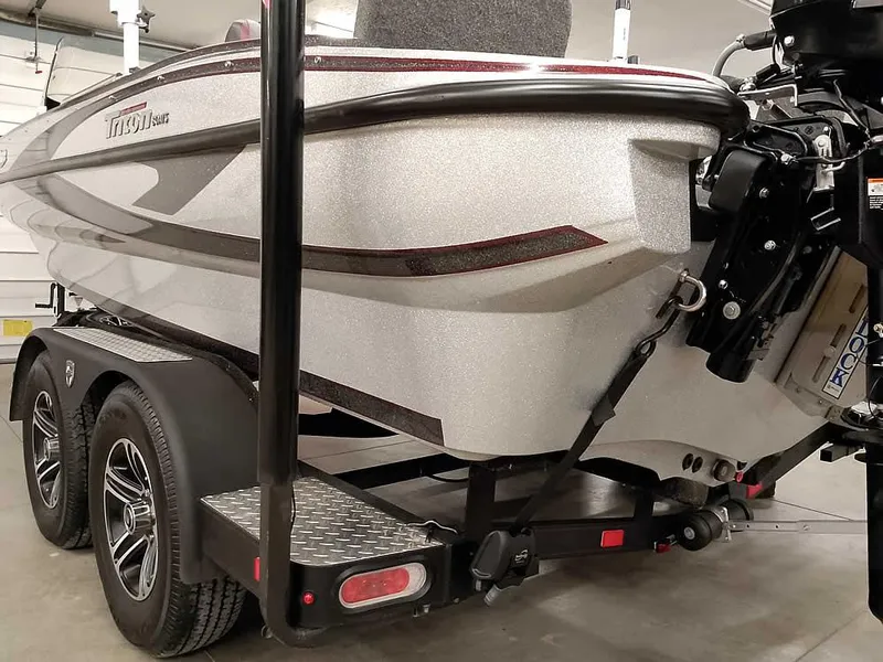 Slide: The Image of 2021 Triton 206 Allure boat on trailer, rear view in garage setting. - 13
