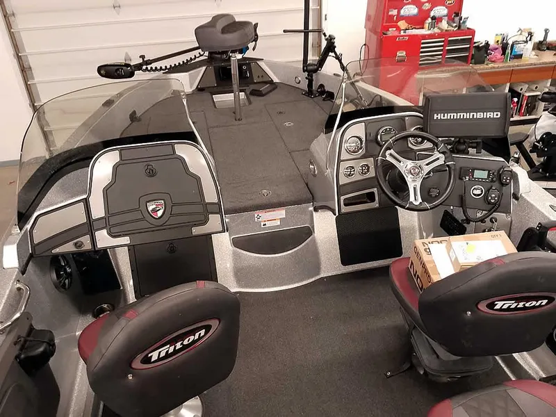 Slide: The Image of 2021 Triton 206 Allure boat interior with steering console and Humminbird electronics. - 15
