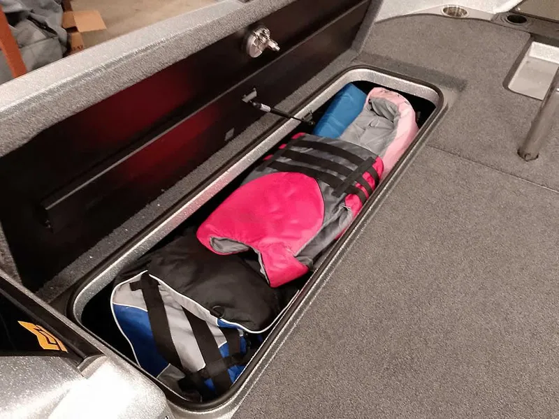 Slide: The Image of Storage compartment in 2021 Triton 206 Allure boat with life jackets neatly organized. - 21