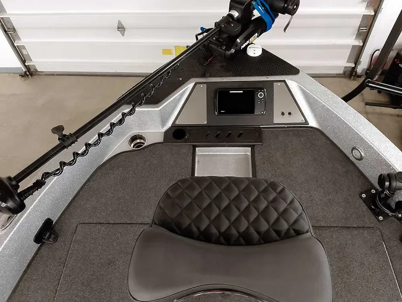 Slide: The Image of 2021 Triton 206 Allure boat interior with control panel and seating. - 22