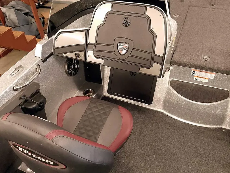 Slide: The Image of 2021 Triton 206 Allure boat interior with steering console and cushioned seat. - 25