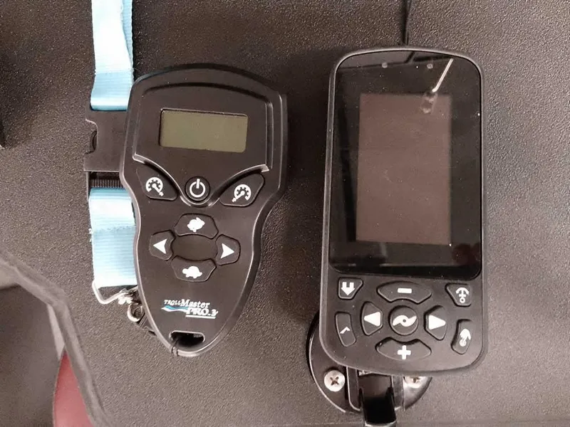 Slide: The Image of Two electronic devices with buttons and screens on a Triton 206 Allure, 2021 model. - 26