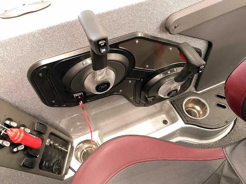 Slide: The Image of 2021 Triton 206 Allure boat controls and seating area with cup holders. - 31