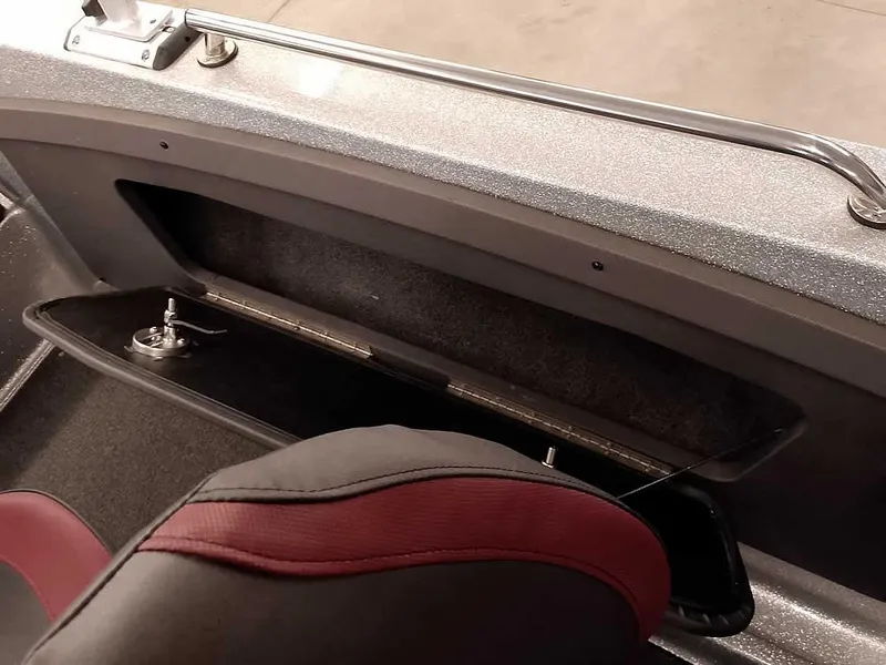 Slide: The Image of 2021 Triton 206 Allure boat interior with open storage compartment and seat detail. - 37