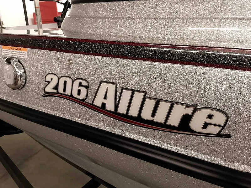 Slide: The Image of 2021 Triton 206 Allure boat with metallic finish and bold lettering. - 4