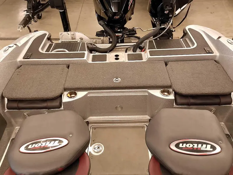 Slide: The Image of 2021 Triton 206 Allure boat interior with seating and motor view. - 40