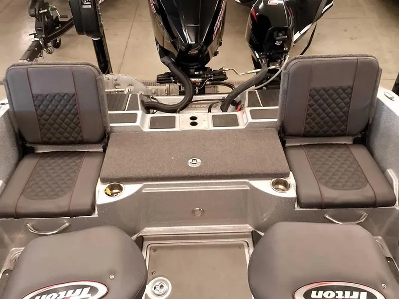 Slide: The Image of 2021 Triton 206 Allure boat interior with dual seats and motor view. - 41