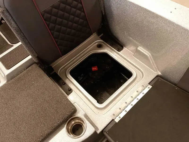 Slide: The Image of 2021 Triton 206 Allure boat interior storage compartment with cup holder and seat detail. - 42
