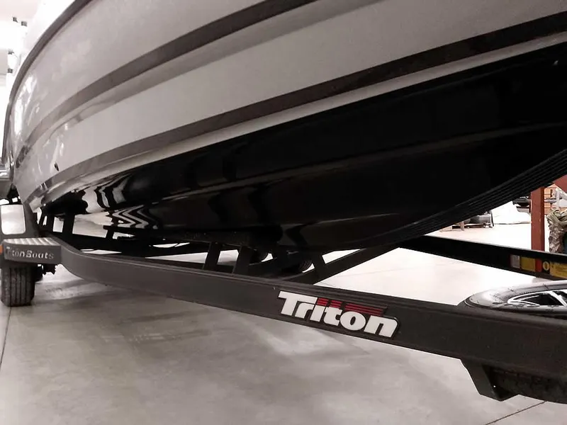Slide: The Image of 2021 Triton 206 Allure boat on trailer, showcasing sleek hull design. - 6