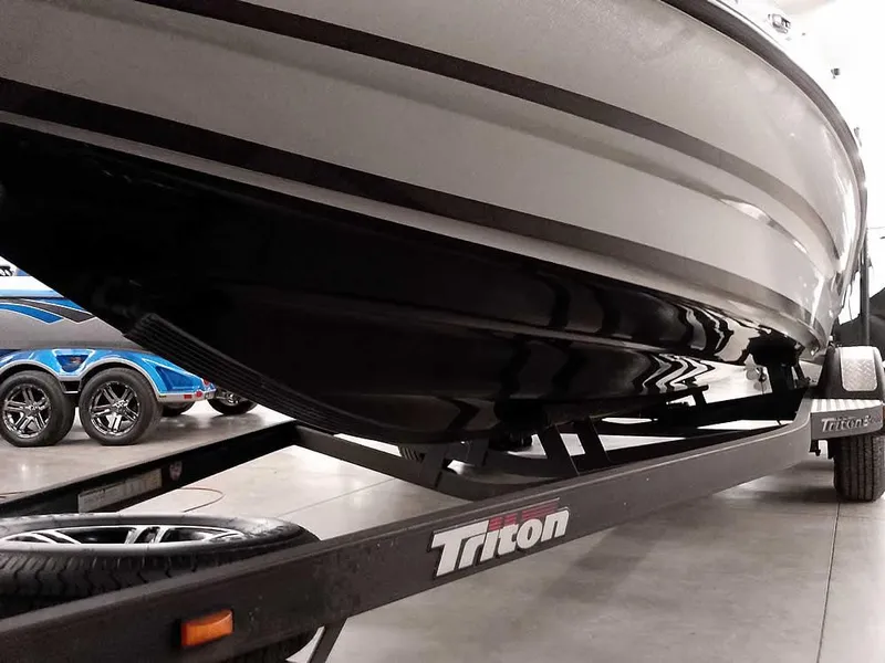 Slide: The Image of 2021 Triton 206 Allure boat on trailer, showcasing sleek hull design. - 8