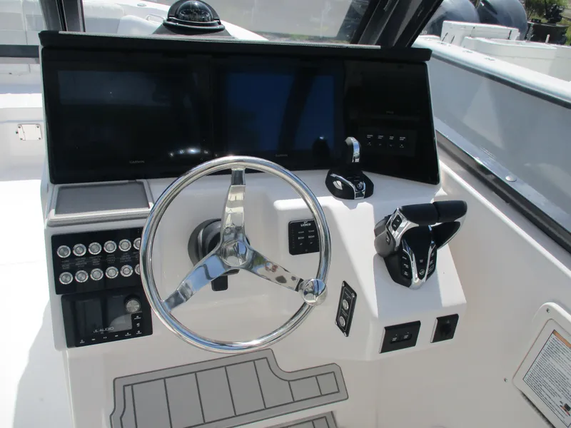 Slide: The Image of 2025 Sea Fox 288 Traveler boat dashboard with steering wheel and control panel. - 15