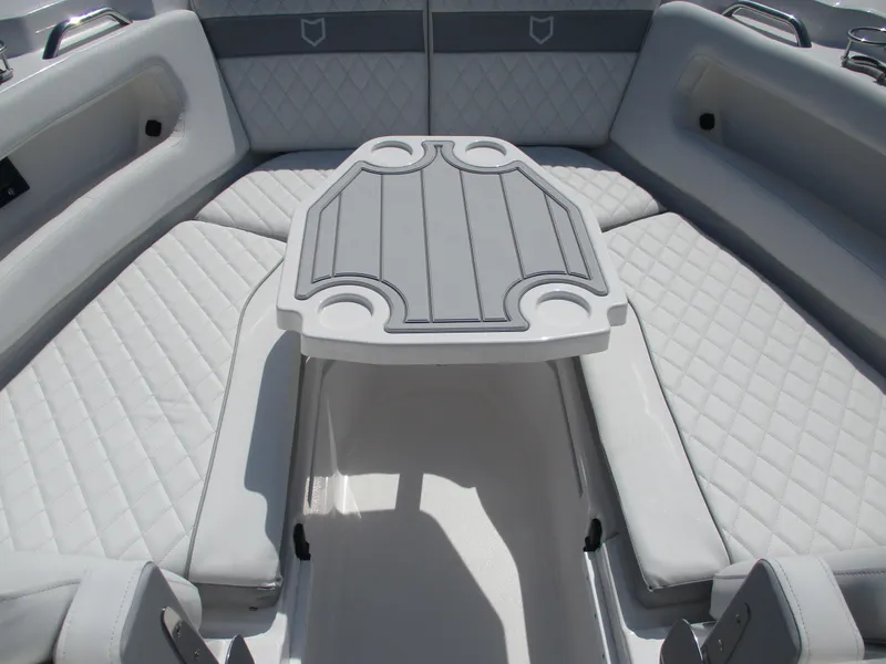 Slide: The Image of 2025 Sea Fox 288 Traveler boat interior with cushioned seating and table. - 16
