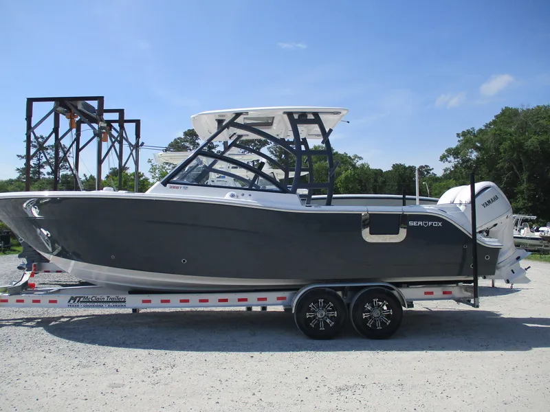 Slide: The Image of 2025 Sea Fox 288 Traveler boat on trailer, side view, outdoors. - 2