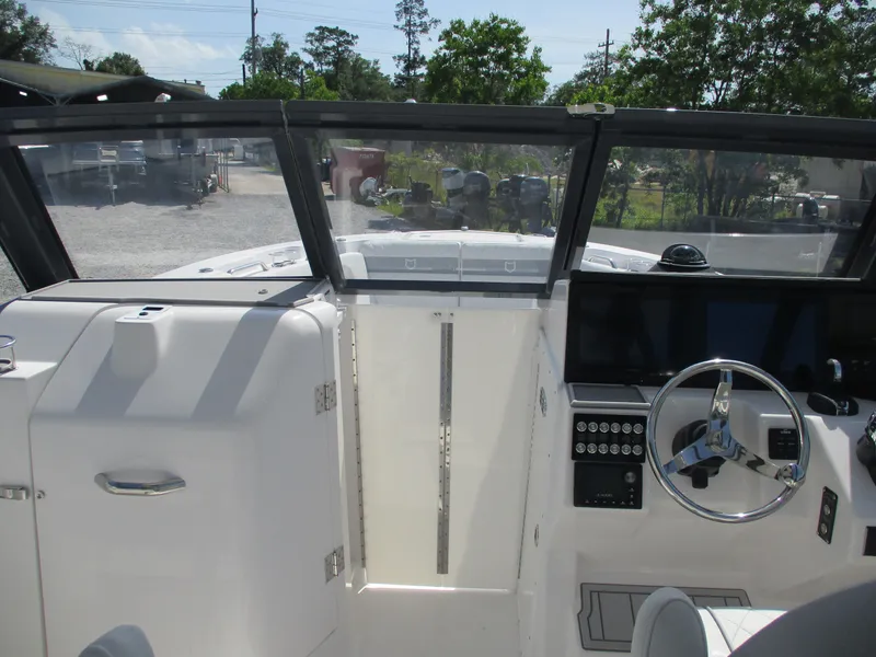 Slide: The Image of 2025 Sea Fox 288 Traveler boat cockpit with steering wheel and control panel. - 8