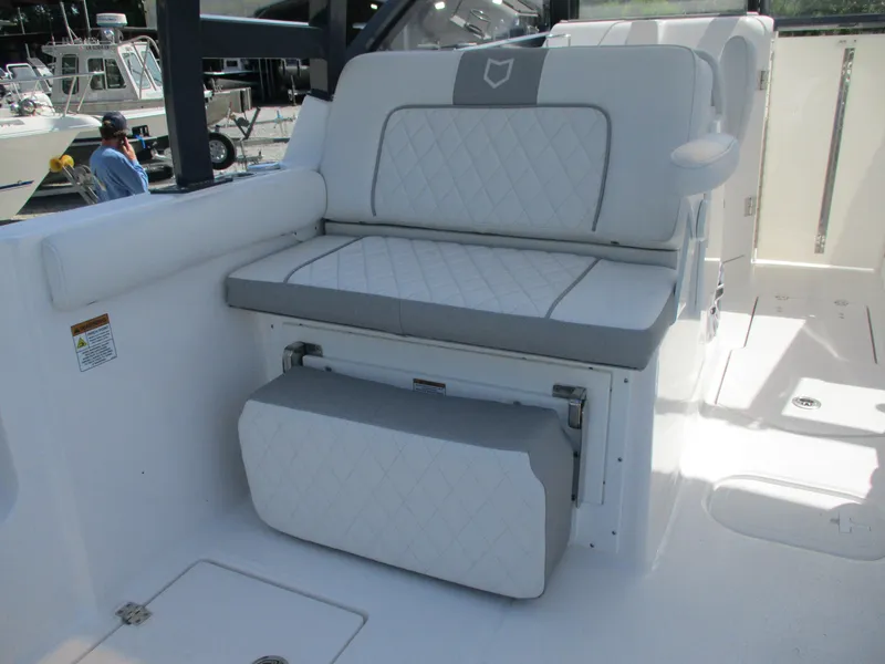 Slide: The Image of 2025 Sea Fox 288 Traveler boat with white cushioned seating and storage compartment. - 9