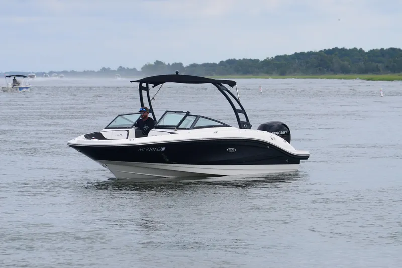 Slide: The Image of 2018 Sea Ray SPX 210 Outboard boat cruising on a calm lake. - 11