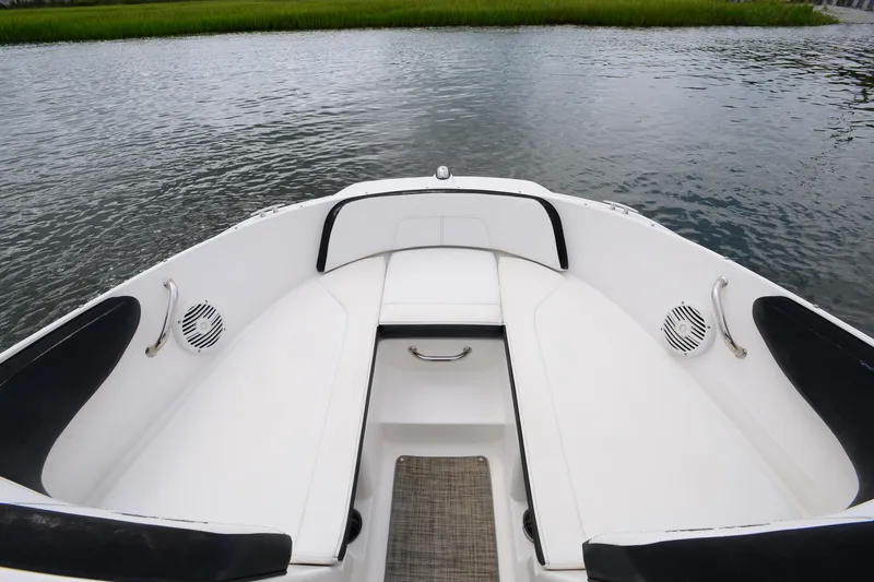 Slide: The Image of 2018 Sea Ray SPX 210 Outboard boat interior with white seating and water view. - 13