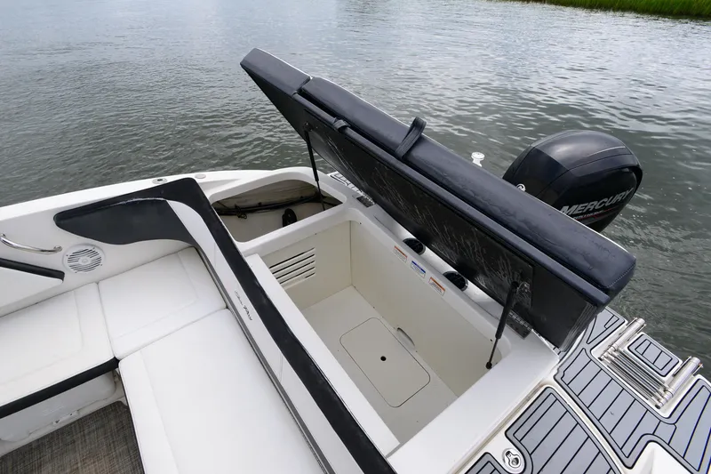 Slide: The Image of 2018 Sea Ray SPX 210 Outboard boat with open storage compartment and Mercury engine. - 20