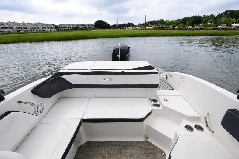 Slide: The Image of 2018 Sea Ray SPX 210 Outboard boat interior with seating, on calm water. - 21