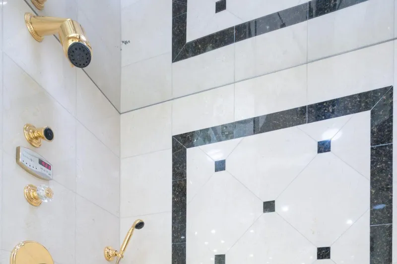 Slide: The Image of Luxurious shower with gold fixtures and elegant black-and-white tile design, Crescent Raised Pilothouse 2004. - 26
