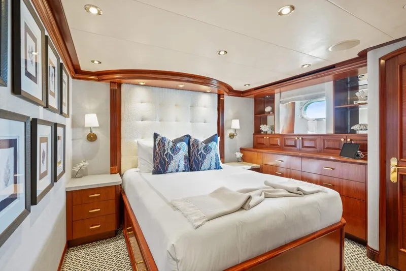 Slide: The Image of Luxurious bedroom interior on 2004 Crescent Raised Pilothouse yacht, featuring elegant wood finishes. - 28
