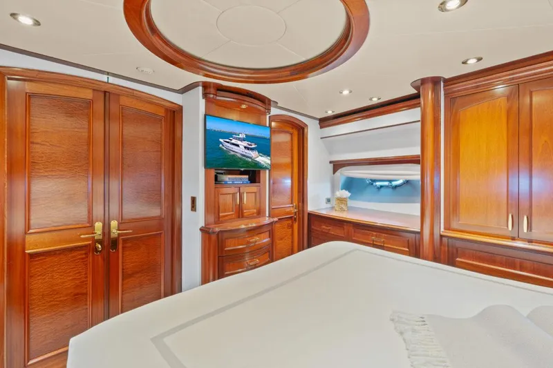 Slide: The Image of Luxurious 2004 Crescent Raised Pilothouse yacht bedroom with elegant wood finishes and modern amenities. - 32