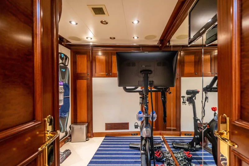 Slide: The Image of Luxurious yacht gym with exercise bike, wooden paneling, and mirrored walls on Crescent Raised Pilothouse 2004. - 34
