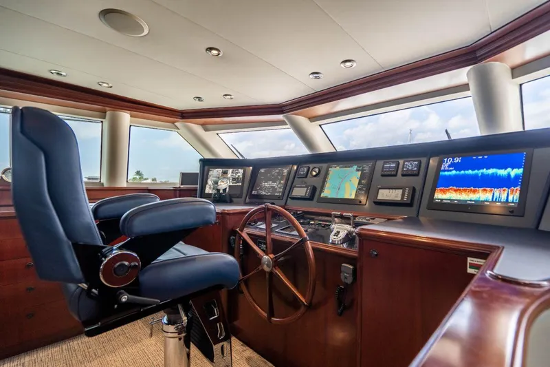 Slide: The Image of Luxurious 2004 Crescent Raised Pilothouse yacht interior with navigation controls and captain's chair. - 42