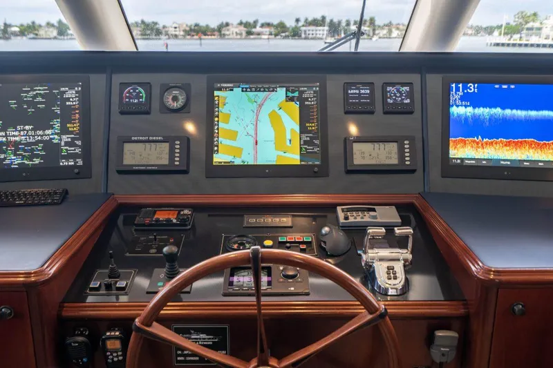 Slide: The Image of Pilothouse of 2004 Crescent Raised Pilothouse yacht with navigation screens and controls. - 43