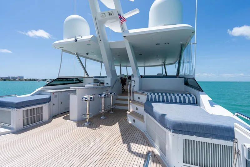 Slide: The Image of Luxurious 2004 Crescent Raised Pilothouse yacht deck with seating, bar stools, and ocean view. - 45
