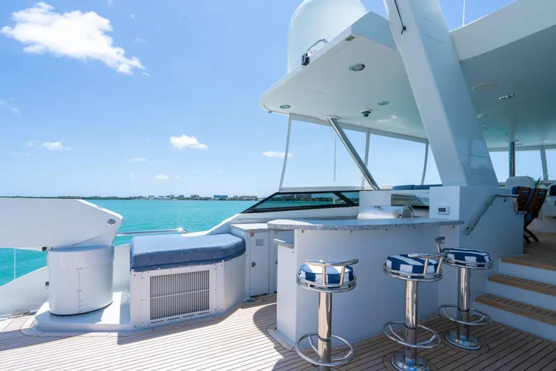 Slide: The Image of Luxurious 2004 Crescent Raised Pilothouse yacht deck with bar stools and ocean view. - 46