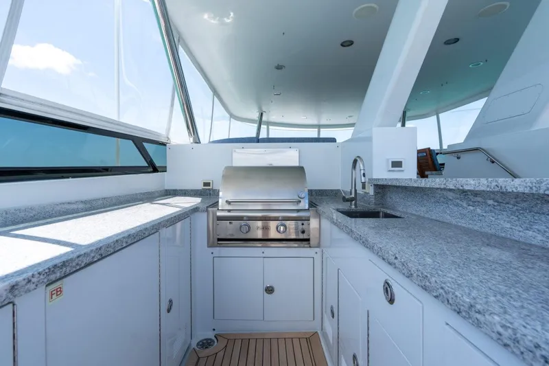 Slide: The Image of Luxurious 2004 Crescent Raised Pilothouse yacht kitchen with grill and granite countertops. - 47