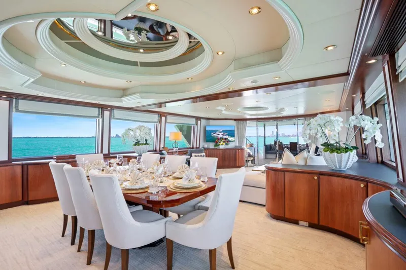 Slide: The Image of Luxurious Crescent Raised Pilothouse yacht interior with elegant dining area, panoramic ocean views, and modern decor. - 7