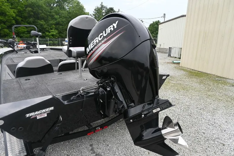 Slide: The Image of 2016 Tracker Pro Team™ 195 TXW boat with Mercury outboard motor, parked on gravel. - 10