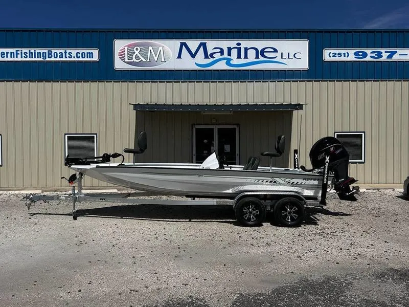 Slide: The Image of 2025 Xpress H20C Crappie boat on trailer outside L&M Marine dealership. - 0