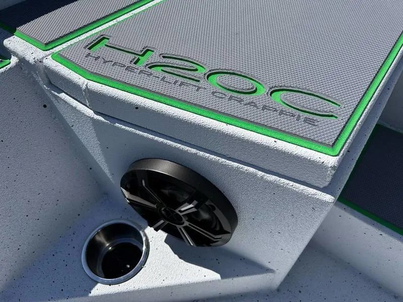 Slide: The Image of 2025 Xpress H20C Crappie boat interior with speaker and cup holder. - 10