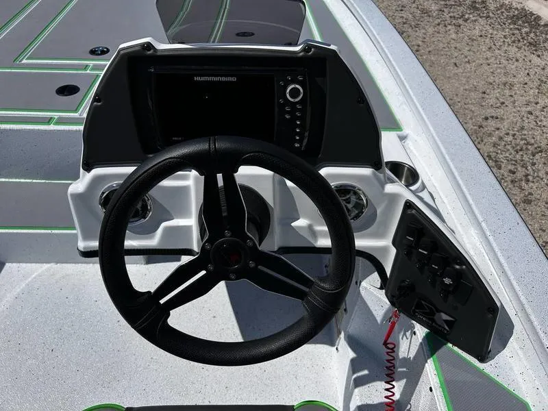 Slide: The Image of 2025 Xpress H20C Crappie boat dashboard with steering wheel and control panel. - 12