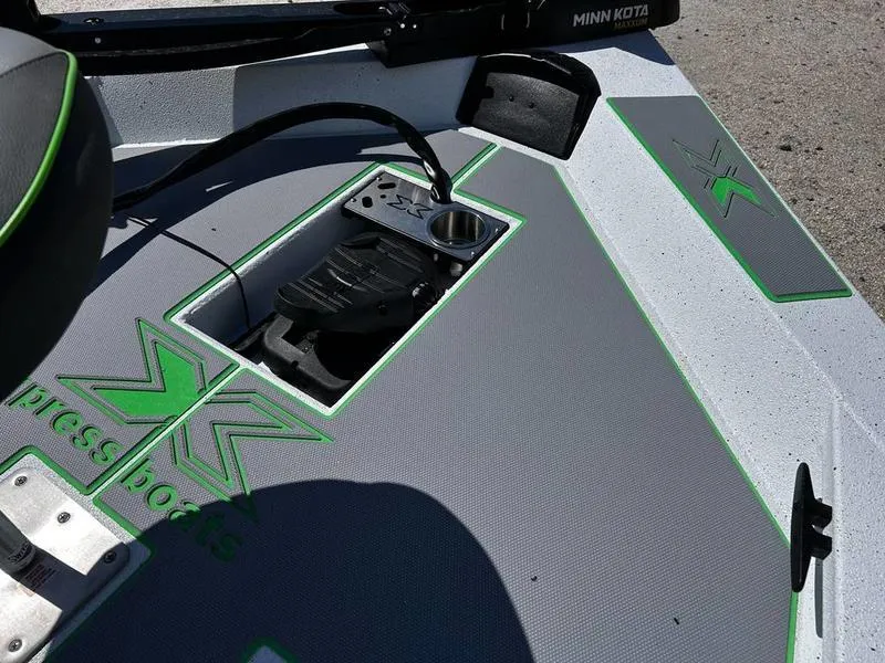 Slide: The Image of 2025 Xpress H20C Crappie boat deck with Minn Kota trolling motor and green accents. - 15