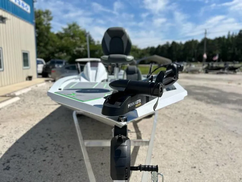 Slide: The Image of 2025 Xpress H20C Crappie boat with Minn Kota trolling motor, parked outdoors. - 2
