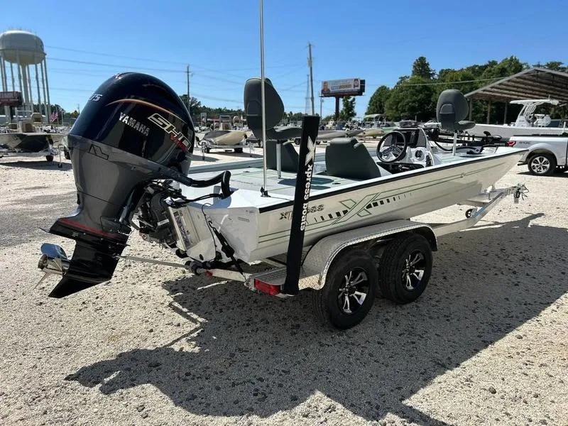Slide: The Image of 2025 Xpress H20C Crappie boat with Yamaha engine on a trailer, parked outdoors. - 3