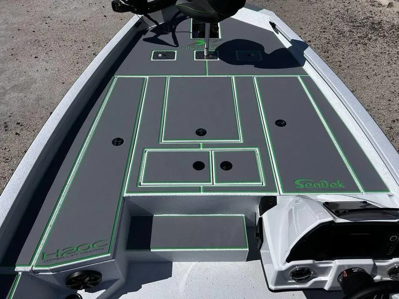 Slide: The Image of 2025 Xpress H20C Crappie boat deck with SeaDek flooring, gray and green design. - 7