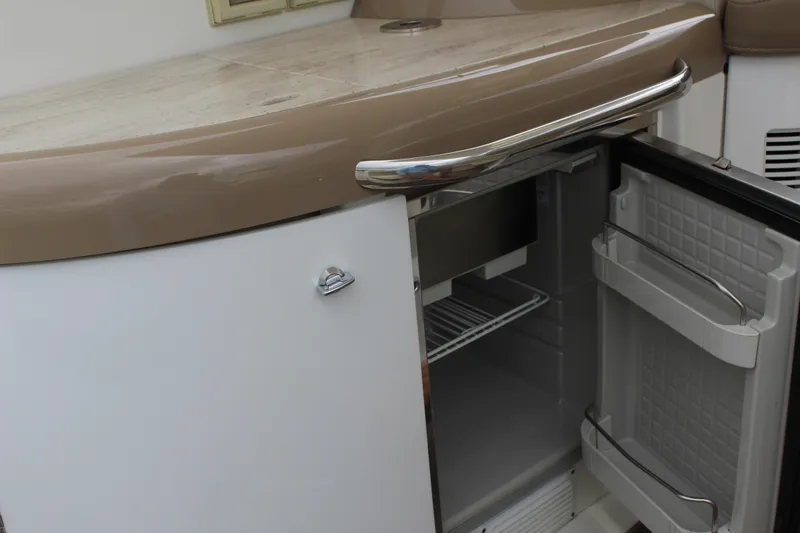 Slide: The Image of 2016 Formula 37 PC yacht interior with open mini fridge and sleek countertop. - 15