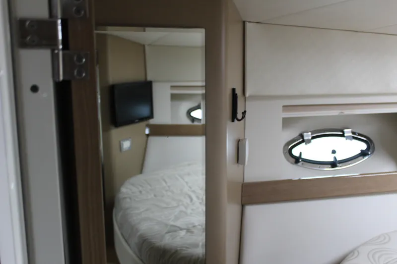 Slide: The Image of 2016 Formula 37 PC yacht interior with bed, TV, and porthole window. - 28