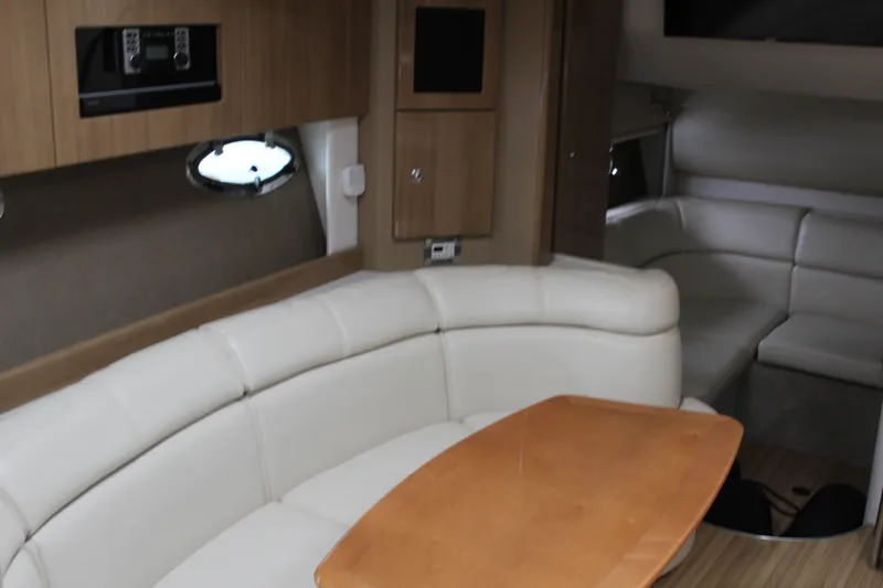 Slide: The Image of Interior of 2016 Formula 37 PC yacht with beige seating and wooden table. - 31