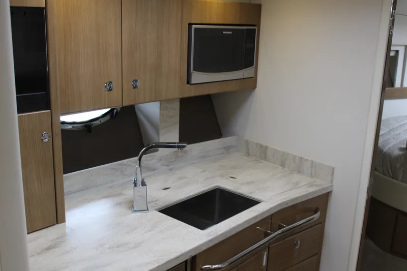 Slide: The Image of 2016 Formula 37 PC yacht kitchen with modern cabinetry and stainless steel appliances. - 37