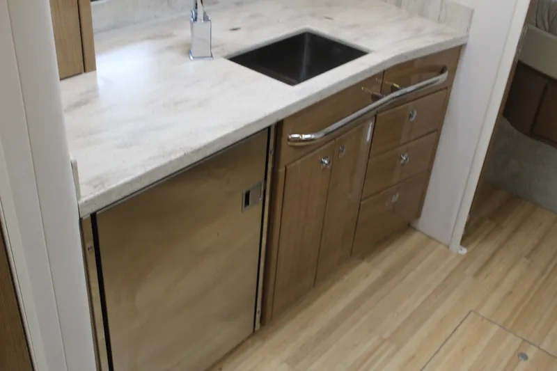 Slide: The Image of 2016 Formula 37 PC kitchen with wood cabinets, stainless steel sink, and modern faucet. - 38