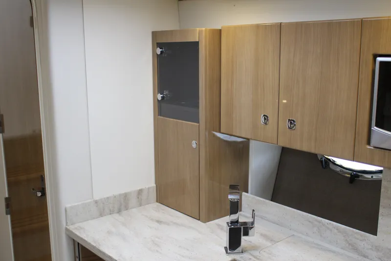 Slide: The Image of 2016 Formula 37 PC yacht bathroom with modern wood cabinetry and sleek fixtures. - 39